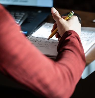 A student writing in a notebook