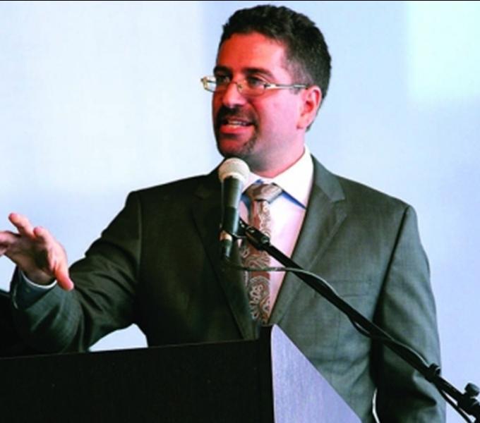 Professor Joshua Bloom speaking at a podium