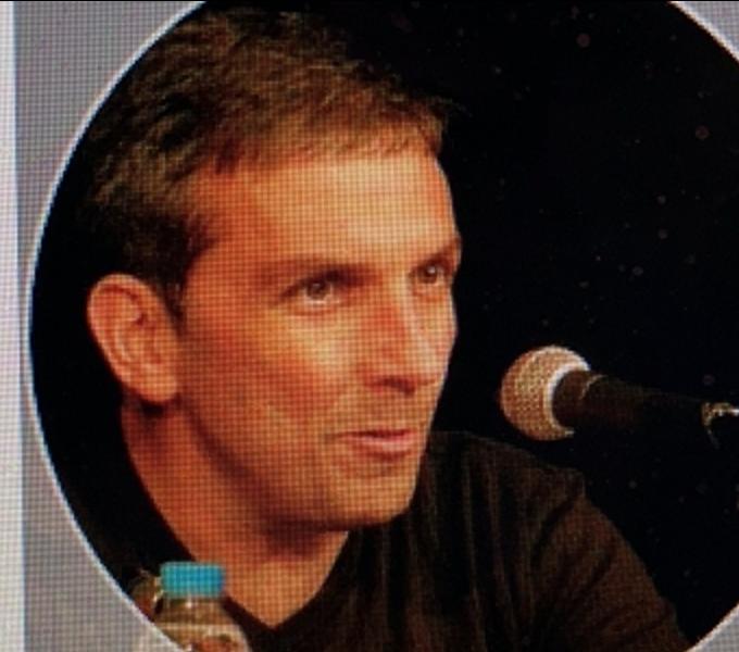 Mike-Frank Epitropoulos speaking in to a microphone