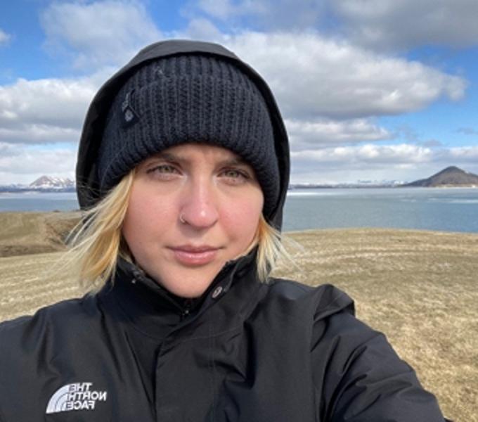 Nicole Troy  standing near a body of water in Iceland