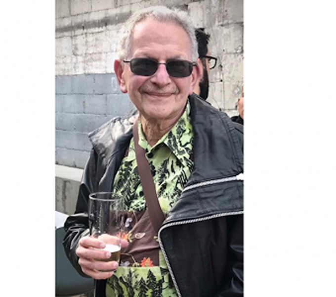 John Markoff standing outside holding a beer